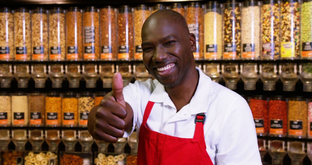 Grocery Store Employee Smiling and Giving Thumbs Up in Bulk Food Aisle - Free Images, Stock Photos and Pictures on Pikwizard.com