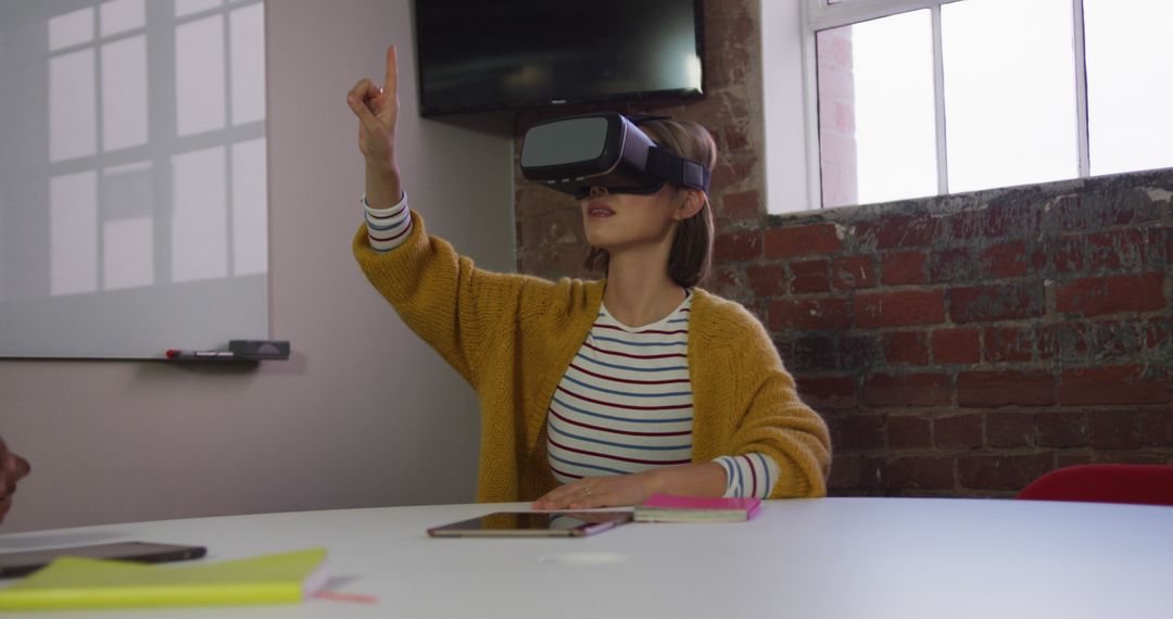 Young Woman Using Virtual Reality Headset in Office Meeting - Free Images, Stock Photos and Pictures on Pikwizard.com