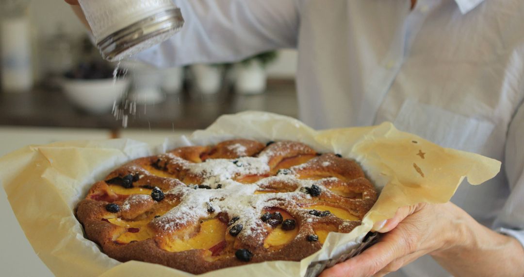 Person Sprinkling Sugar Over Freshly Baked Fruit Tart - Free Images, Stock Photos and Pictures on Pikwizard.com