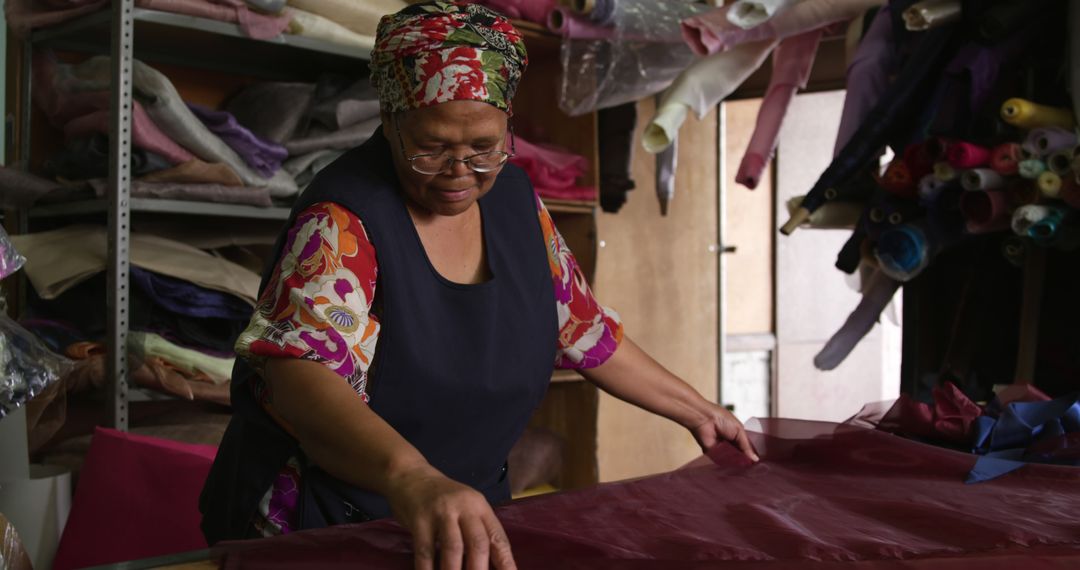 Female Shop Owner Sorting Fabrics in Textile Store - Free Images, Stock Photos and Pictures on Pikwizard.com