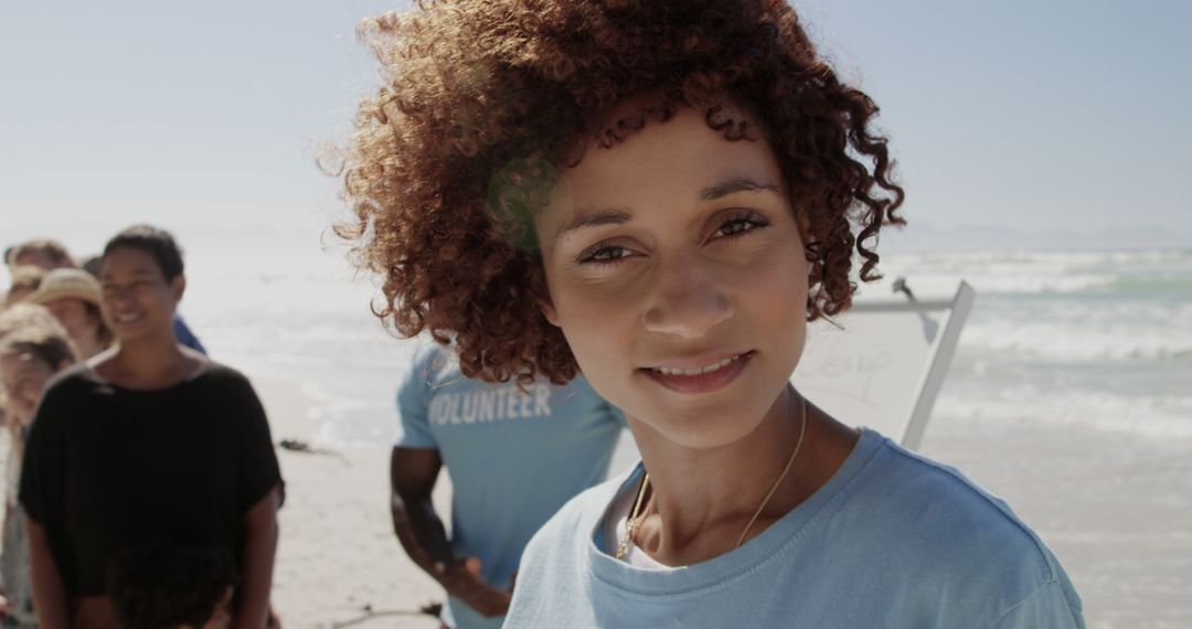 Smiling Volunteer Woman Participating in Beach Cleanup Event - Free Images, Stock Photos and Pictures on Pikwizard.com