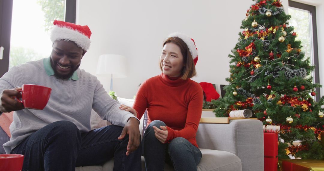 Diverse Couple Celebrating Christmas at Home with Tree and Gifts - Free Images, Stock Photos and Pictures on Pikwizard.com