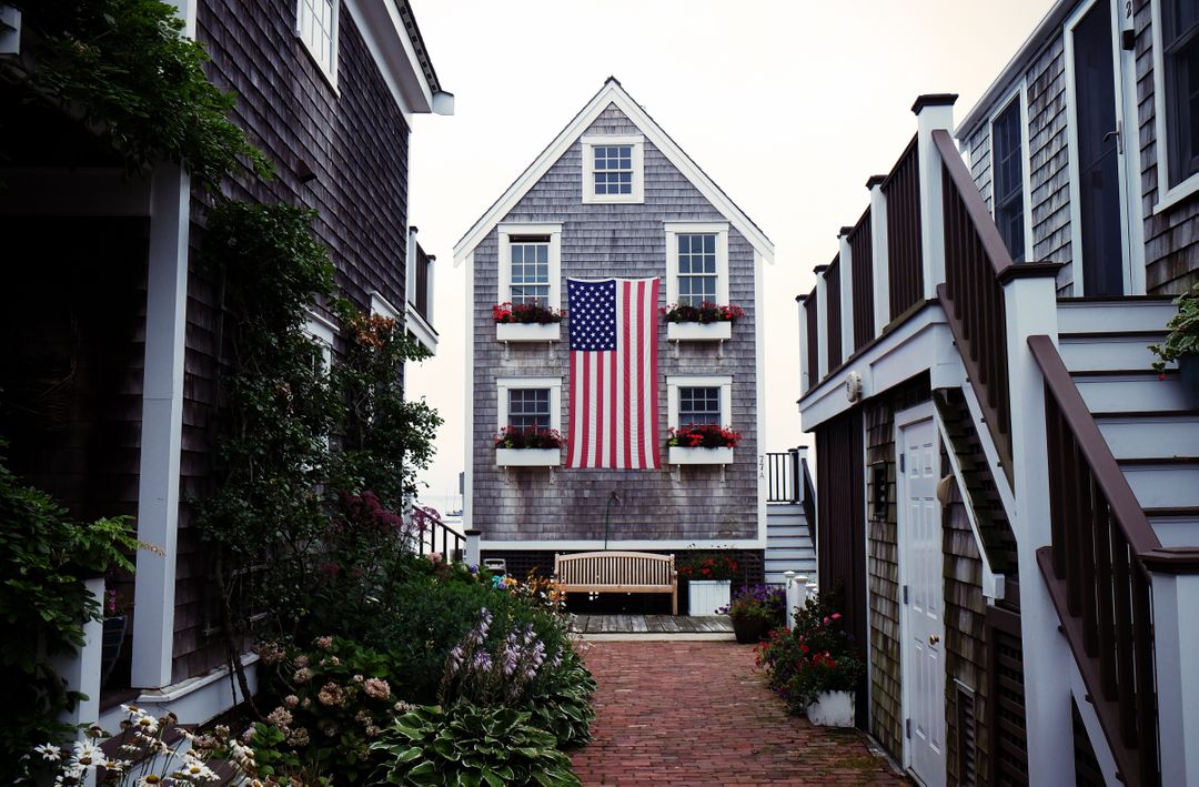 Classic American Home with Flag and Cozy Walkway - Free Images, Stock Photos and Pictures on Pikwizard.com