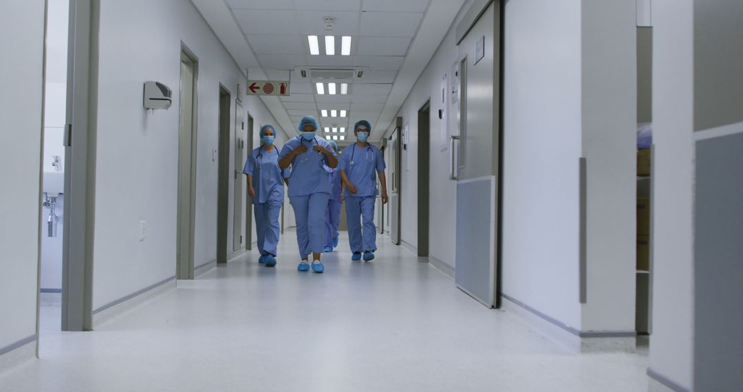 Healthcare Workers Walking Through Hospital Corridor - Free Images, Stock Photos and Pictures on Pikwizard.com