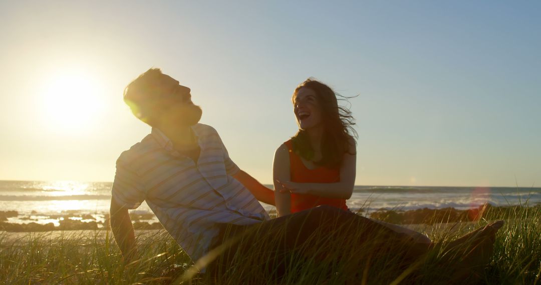 Happy Couple Laughing on the Beach at Sunset - Free Images, Stock Photos and Pictures on Pikwizard.com