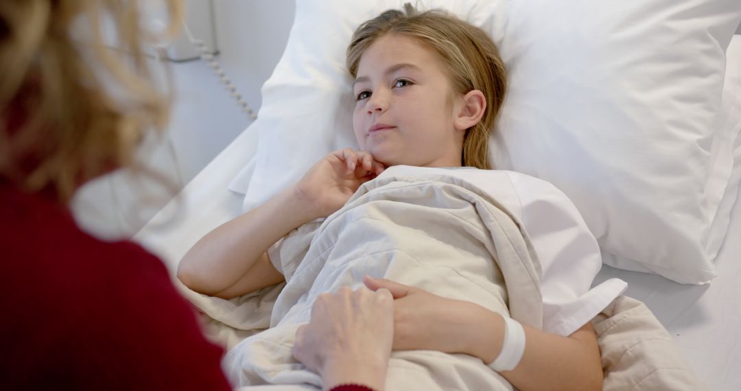 Young Patient Resting in Hospital Bed with Caring Visitor - Free Images, Stock Photos and Pictures on Pikwizard.com