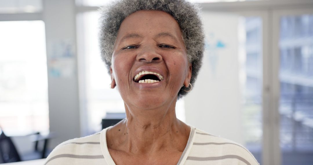 Elderly Woman Smiling in Bright Room - Free Images, Stock Photos and Pictures on Pikwizard.com