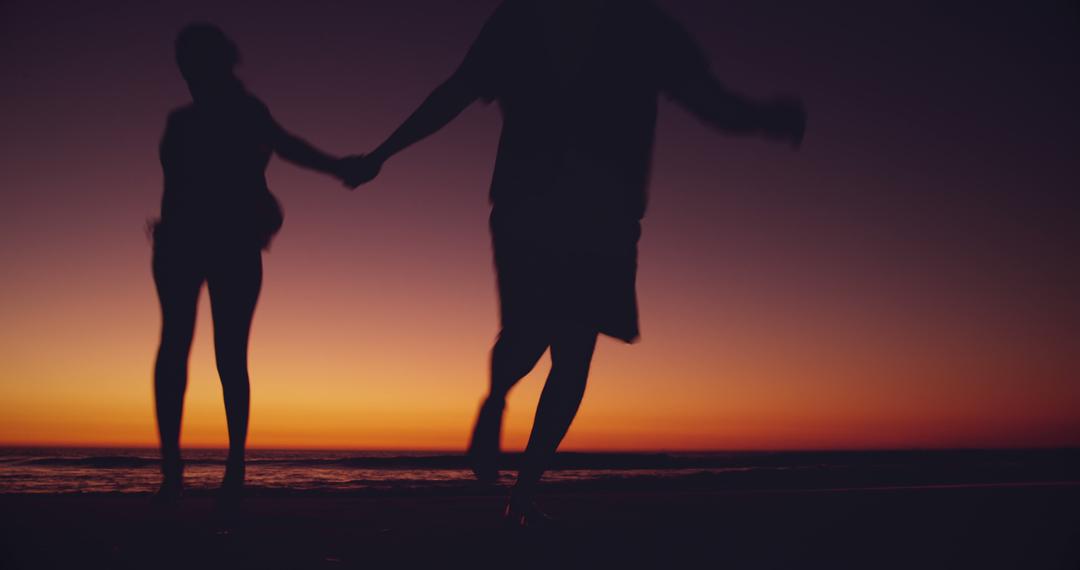 Silhouette Couple Running on Beach at Sunset - Free Images, Stock Photos and Pictures on Pikwizard.com