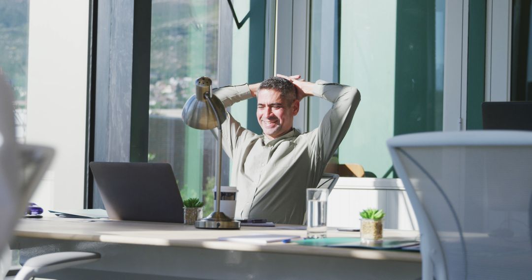 Businessman Relaxing at Desk in Modern Office - Free Images, Stock Photos and Pictures on Pikwizard.com