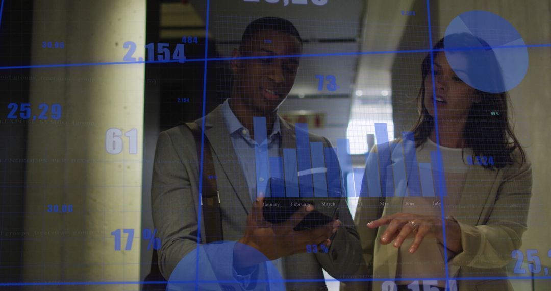 Diverse Business Professionals Analyzing Digital Graphs on Tablet