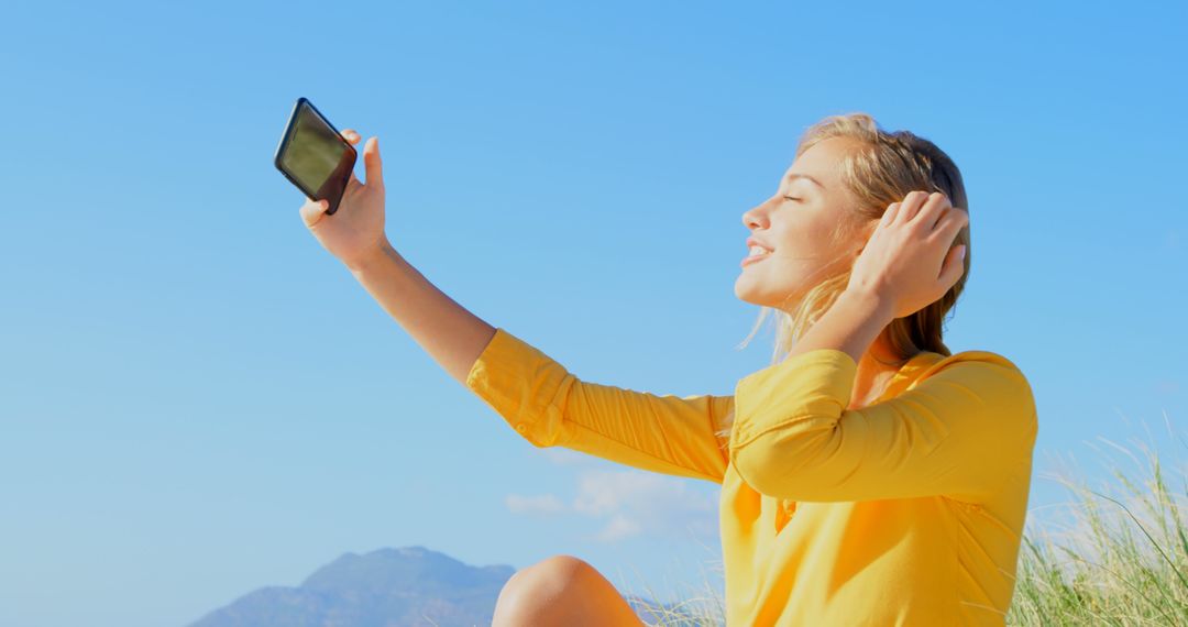 Smiling Woman Taking Selfie on Beach in Sunny Weather - Free Images, Stock Photos and Pictures on Pikwizard.com