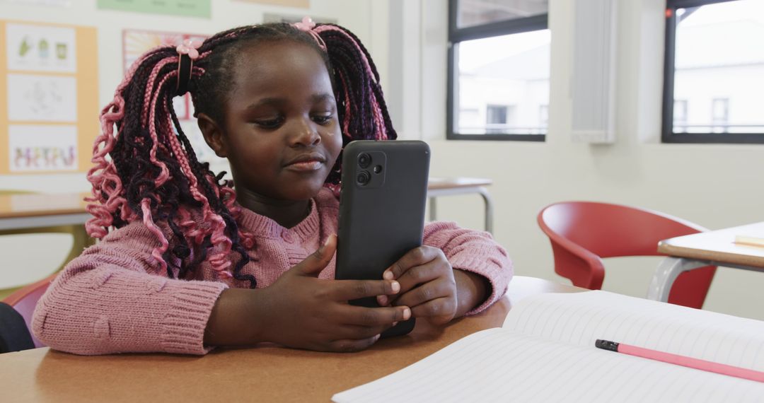 Girl in Classroom Using Smartphone for Study Assistance