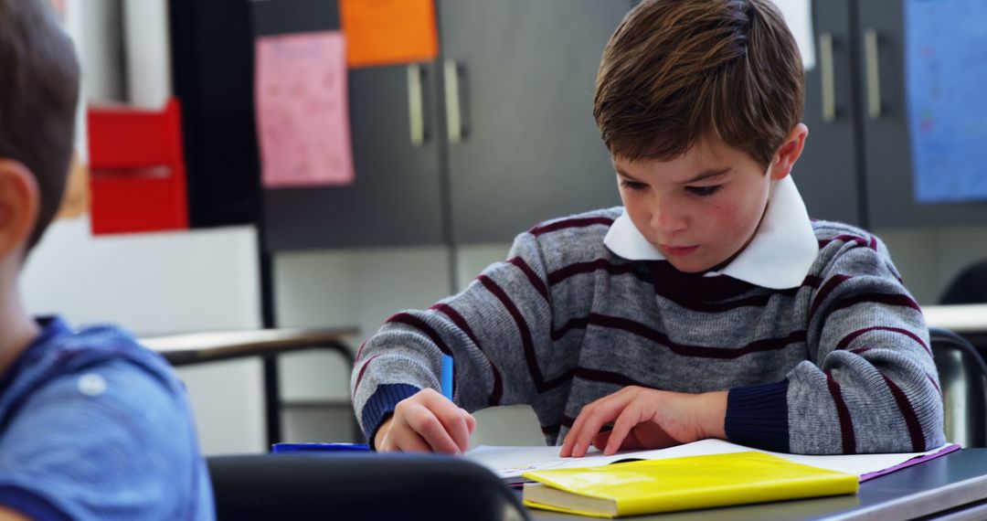 Focused Schoolboy Engaged in Classroom Study