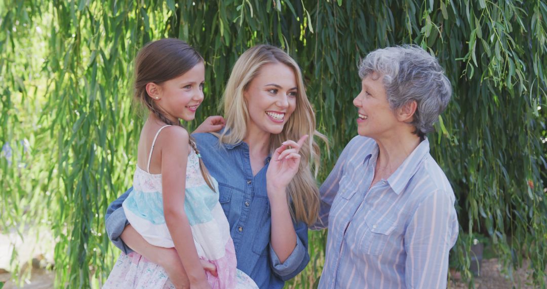 Three Generations of Women Smiling in Garden Embrace - Free Images, Stock Photos and Pictures on Pikwizard.com