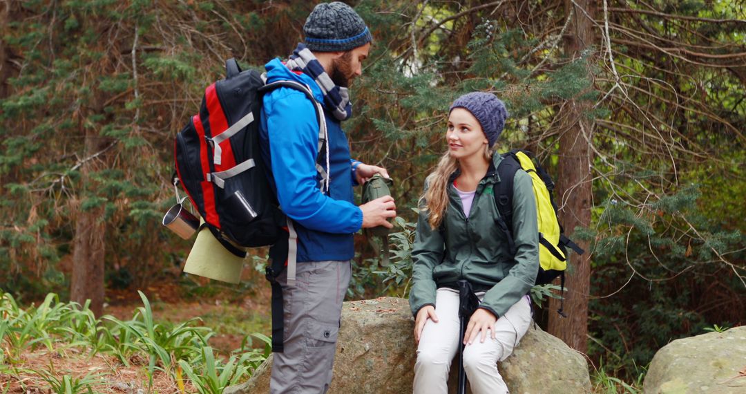 Couple Hiking in Forest Enjoying Break Together