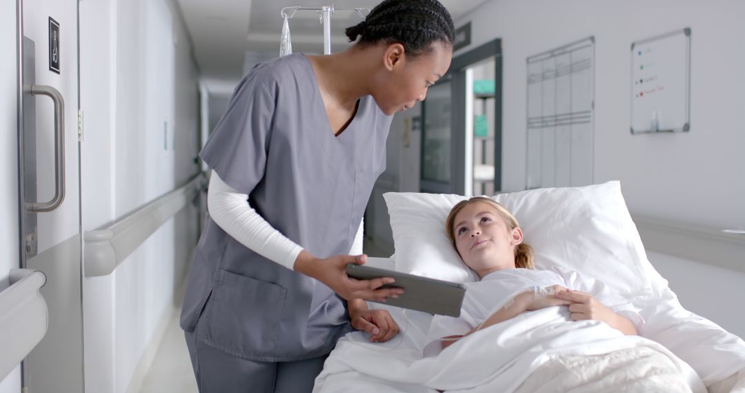 Nurse consulting young patient in hospital bed with digital tablet - Free Images, Stock Photos and Pictures on Pikwizard.com