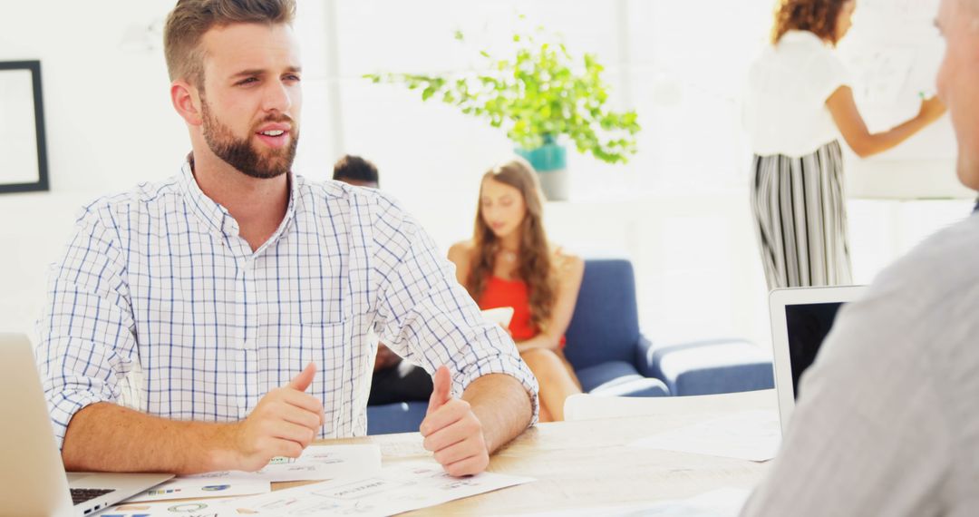 Colleagues Engaging in Discussion in Modern Office