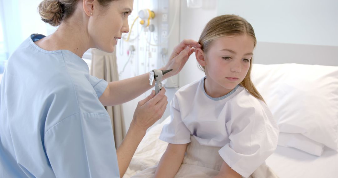 Pediatric doctor examining young patient with otoscope in hospital - Free Images, Stock Photos and Pictures on Pikwizard.com