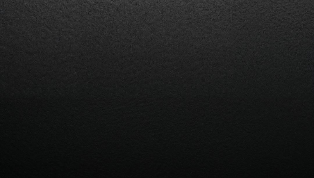 Textured Charcoal Surface with Subtle Gradient and Fine Pebbled Grain High-Res Matte Black Backdrop