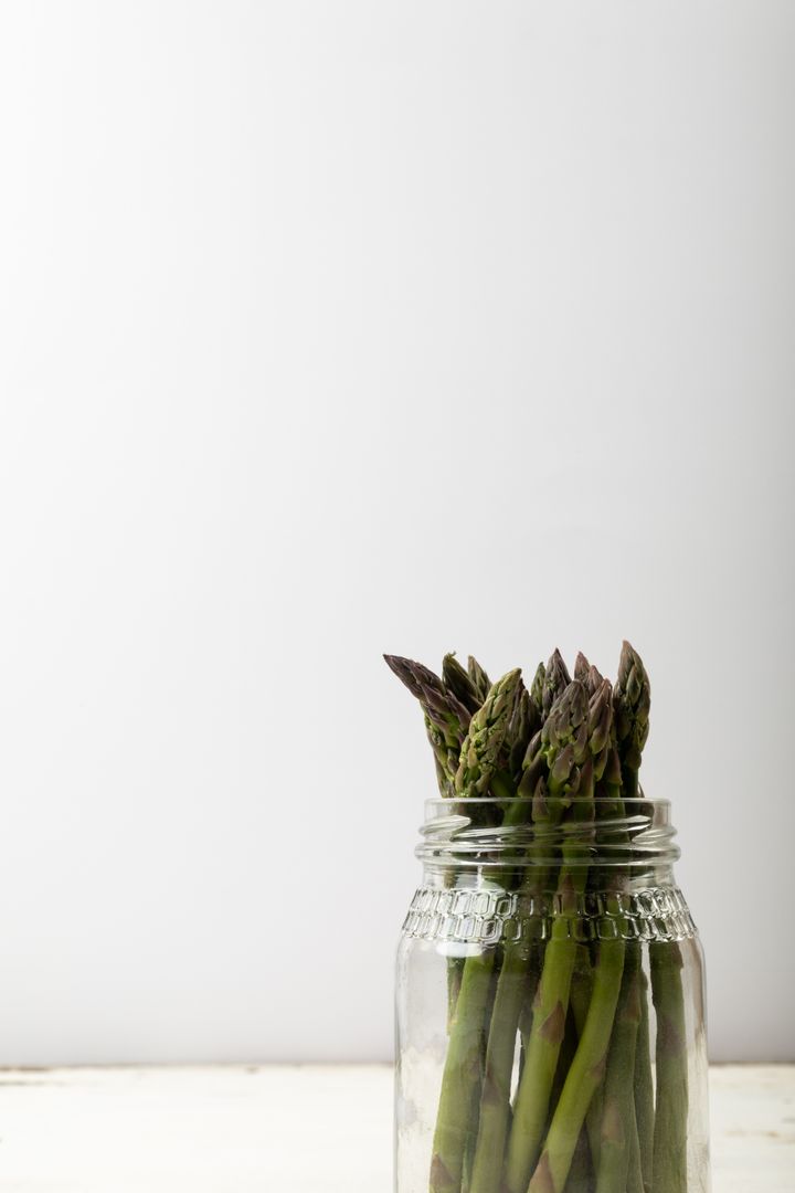 Close-up of asparagus in jar against white background, copy space - Free Images, Stock Photos and Pictures on Pikwizard.com