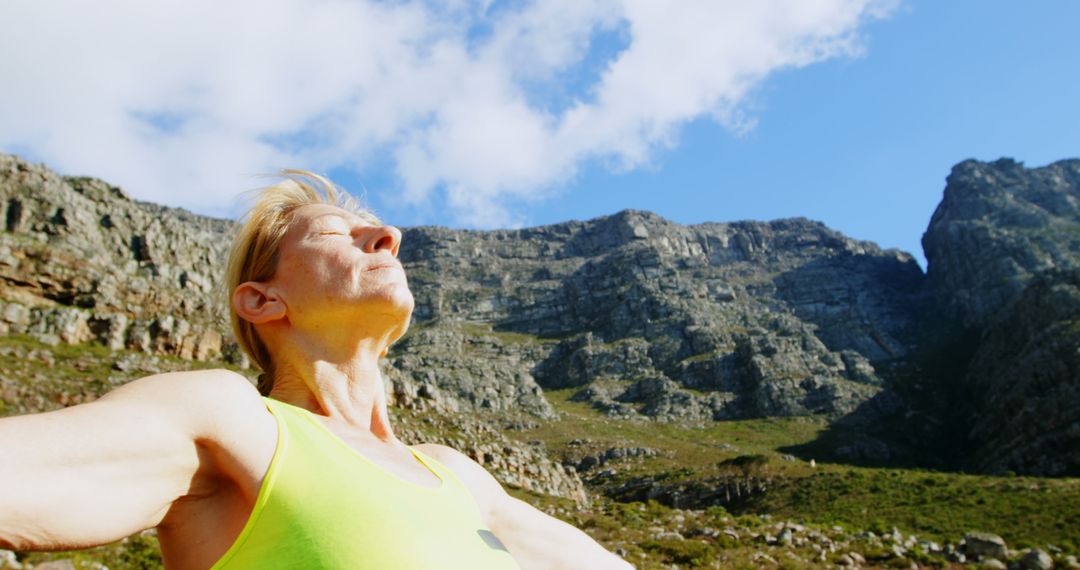 Senior Woman Enjoying Fresh Air in Mountainous Landscape - Free Images, Stock Photos and Pictures on Pikwizard.com