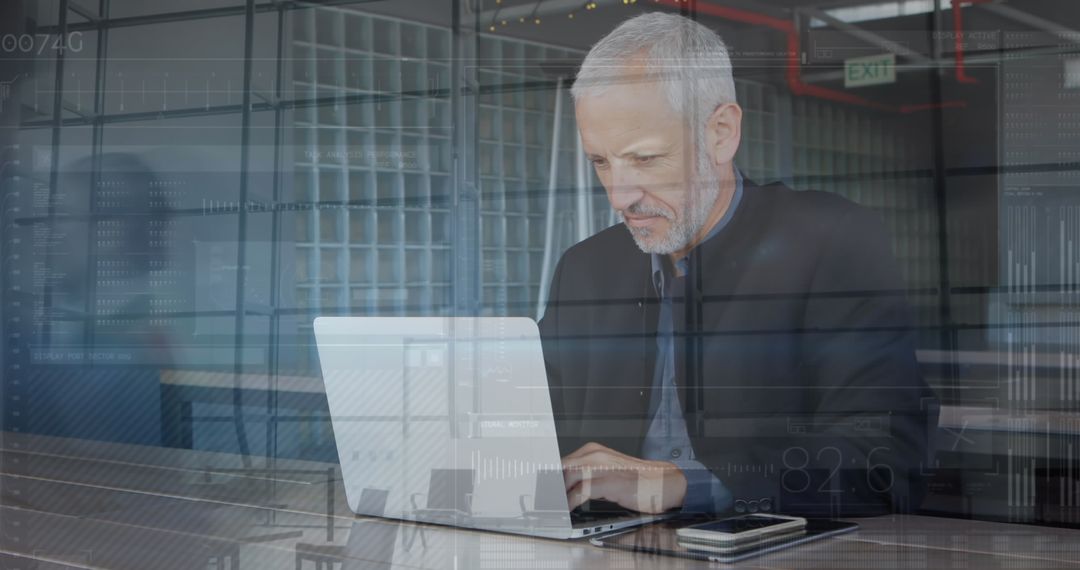 Senior Businessman Using Laptop in Modern Office Environment