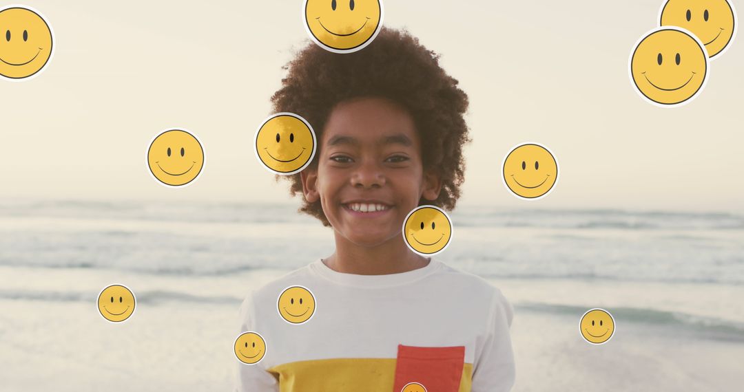 Joyful african american child with emoticons on sunny beach