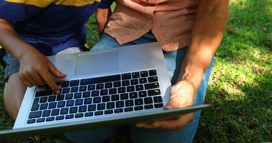 Child and Adult Using Laptop Outdoors - Free Images, Stock Photos and Pictures on Pikwizard.com