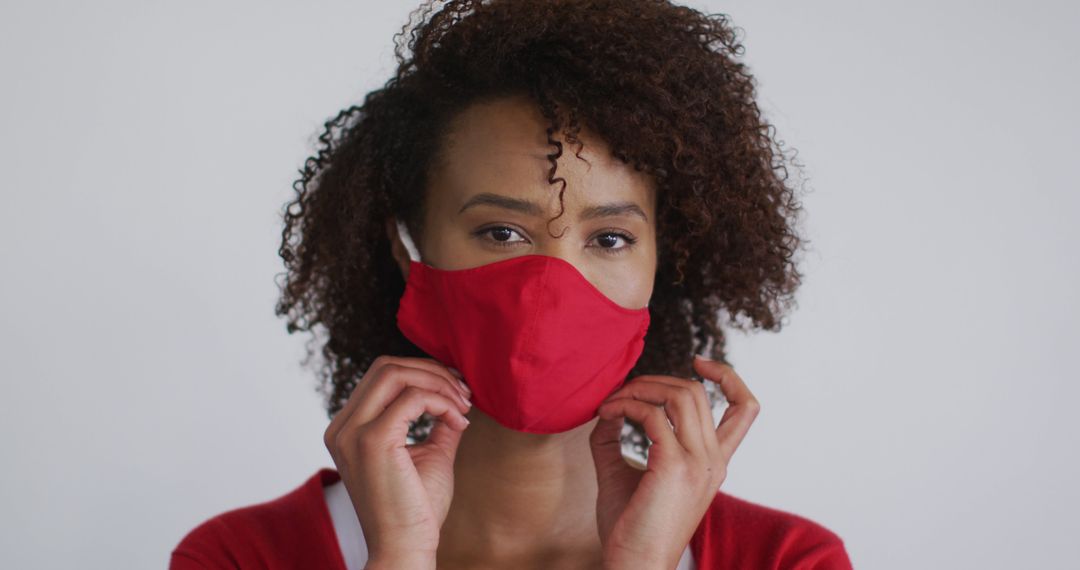 Portrait of biracial woman putting mask on - Free Images, Stock Photos and Pictures on Pikwizard.com