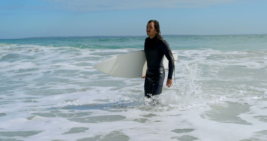 Man walking with surfboard on the sea at beach 4k - Free Images, Stock Photos and Pictures on Pikwizard.com