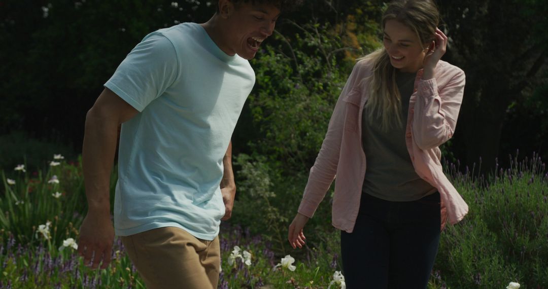 Joyful Diverse Couple Enjoying Playful Moment in Garden Setting