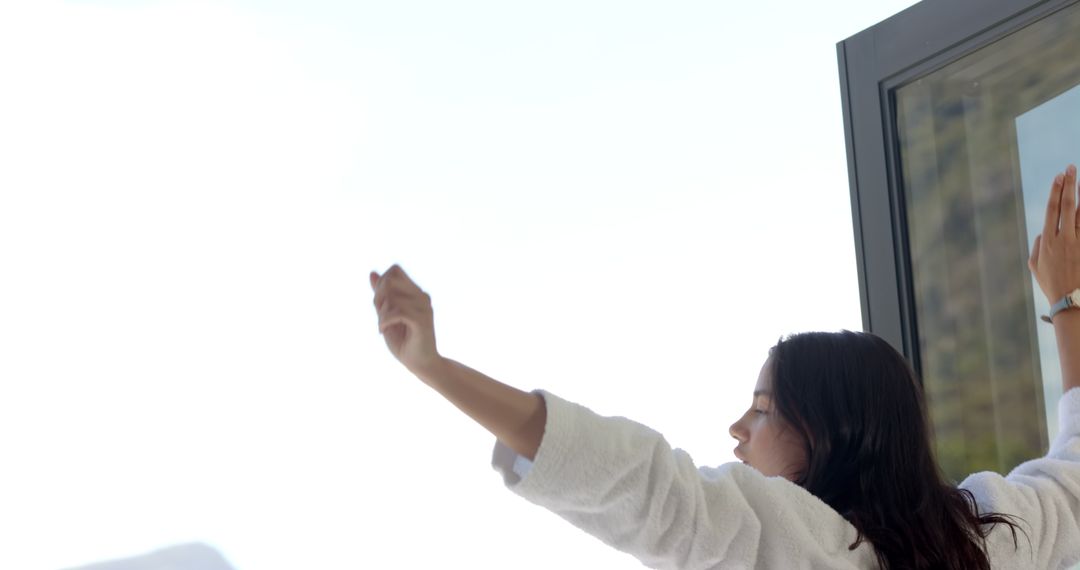 Teenage Girl Embracing Morning Sunshine on Balcony