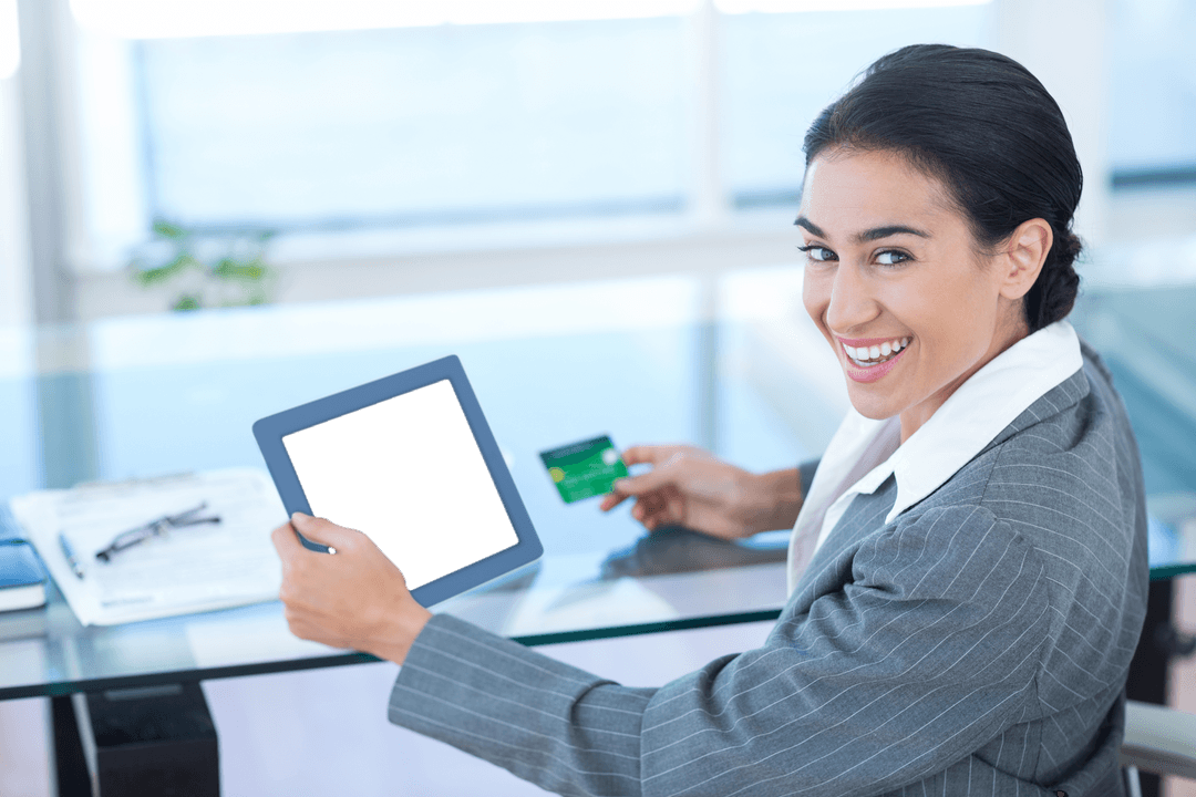 Businesswoman Using Tablet and Credit Card in Office Environment