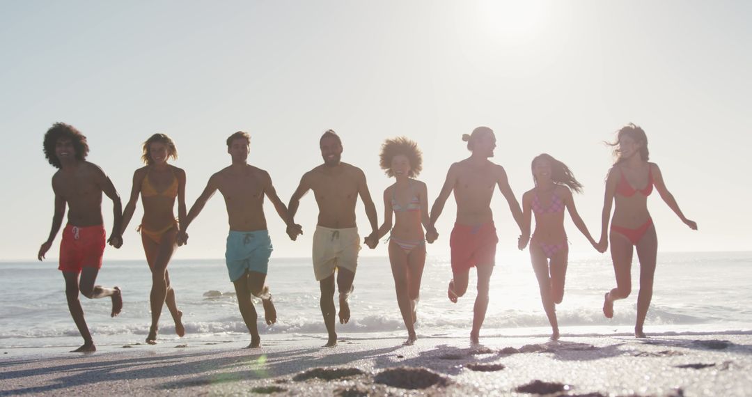 Group of Friends Running on Beach at Sunset - Free Images, Stock Photos and Pictures on Pikwizard.com