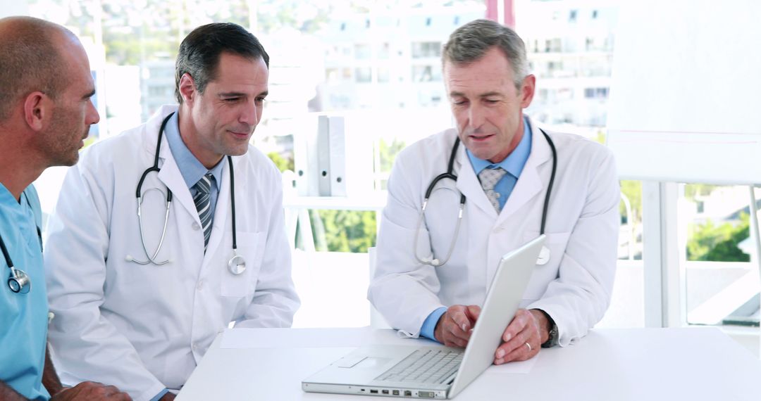 Doctors Discussing Patient Information on Laptop - Free Images, Stock Photos and Pictures on Pikwizard.com