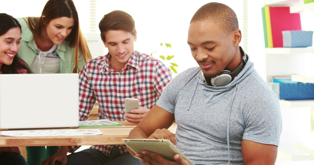 Diverse Young Adults in Tech-Savvy Collaborative Environment