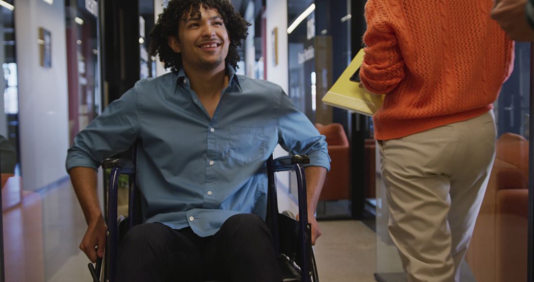 Young Man in Wheelchair in Modern Office Environment - Free Images, Stock Photos and Pictures on Pikwizard.com