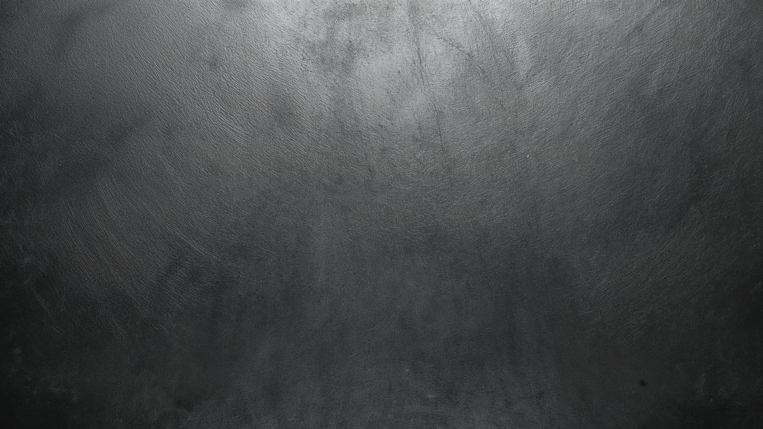 Matte Dark Textured Surface Under Soft Shimmering Studio Lighting