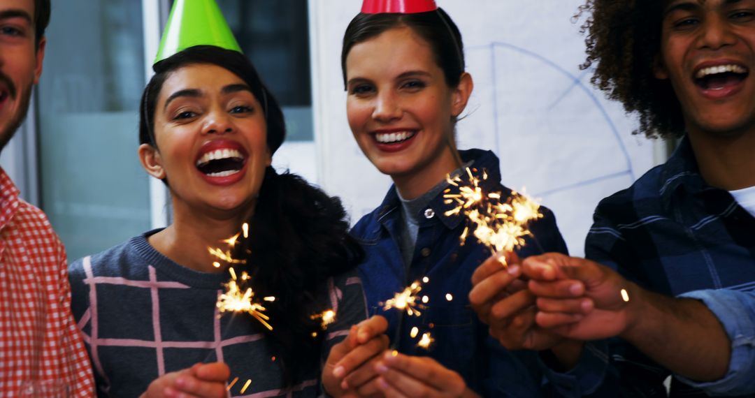 Joyful Office Celebration with Happy Team and Sparklers - Free Images, Stock Photos and Pictures on Pikwizard.com