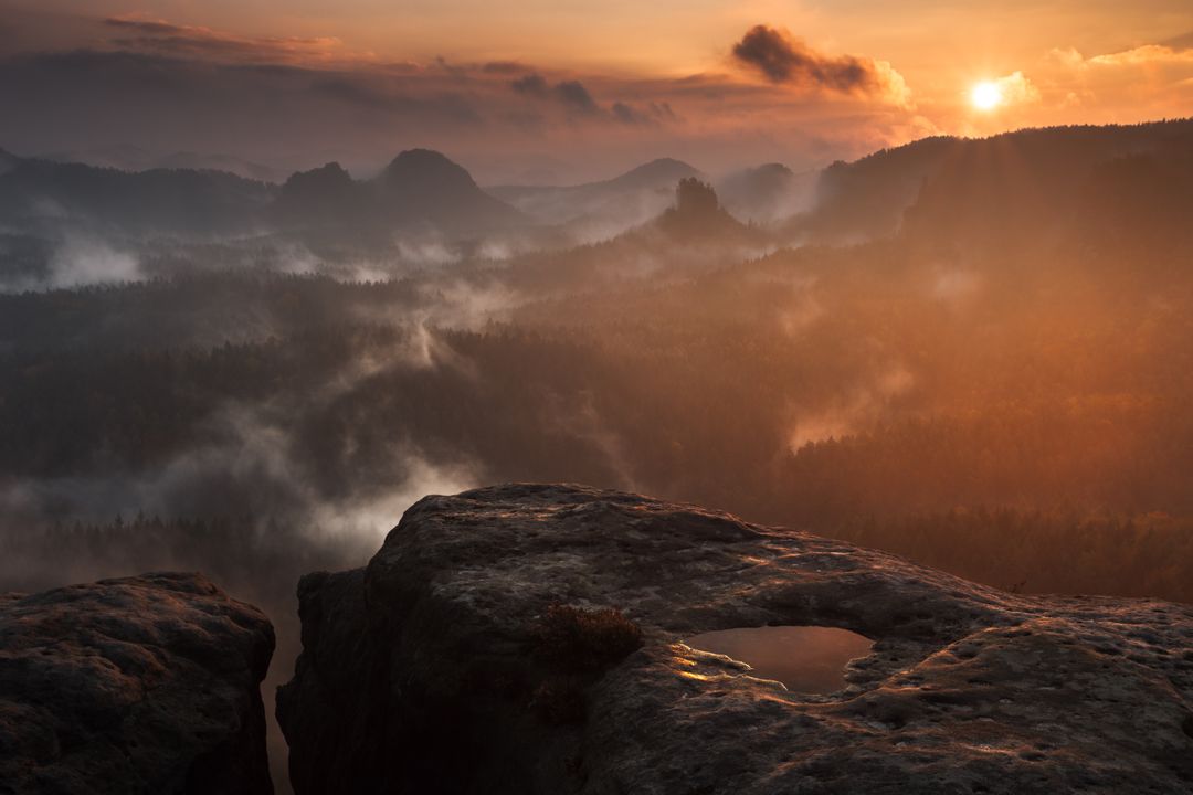 Misty Mountain Sunset with Dramatic Skies and Rock Formations - Free Images, Stock Photos and Pictures on Pikwizard.com