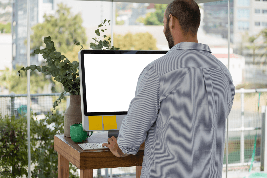 Creative Designer Working at Transparent Standing Desk