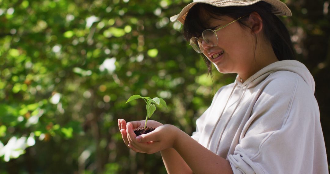 Young Woman Holding Seedling in a Forest - Free Images, Stock Photos and Pictures on Pikwizard.com