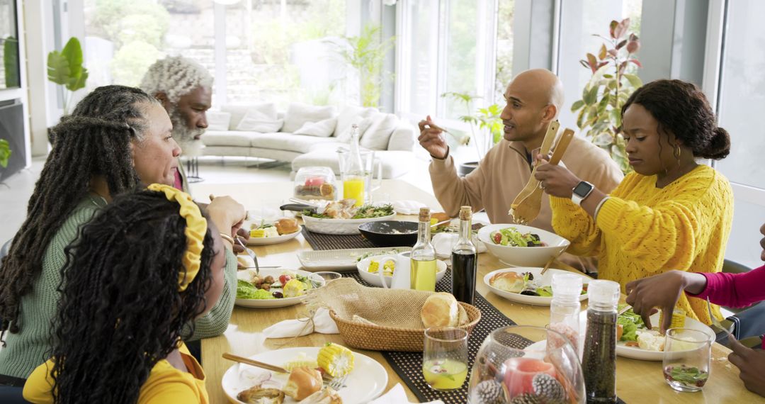 Multigenerational family sharing sunlit healthy meal around modern open-plan dining table