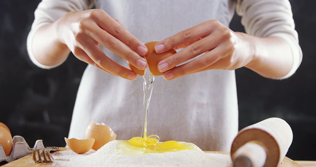 Close-Up of Person's Hands Cracking Egg into Flour for Baking - Free Images, Stock Photos and Pictures on Pikwizard.com