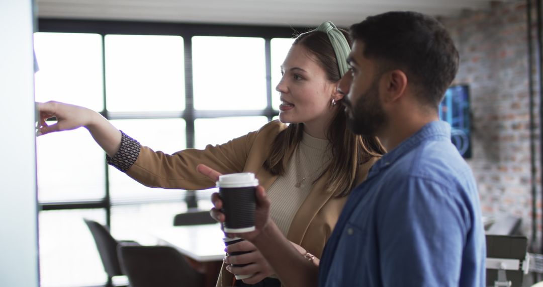 Colleagues Collaborate Discussing Project with Coffee