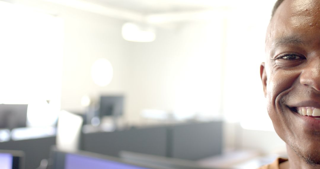 Confident Businessman Smiling In Sunny Office Environment