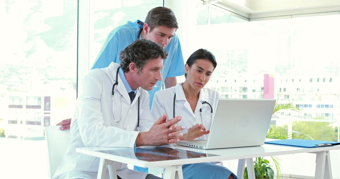 Doctors and Nurse Collaborating on Digital Patient Records - Free Images, Stock Photos and Pictures on Pikwizard.com