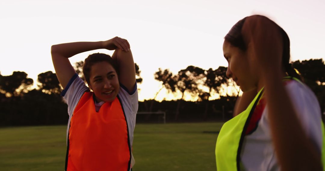 Women Athletes Stretching in Sunset at Outdoor Soccer Field - Free Images, Stock Photos and Pictures on Pikwizard.com