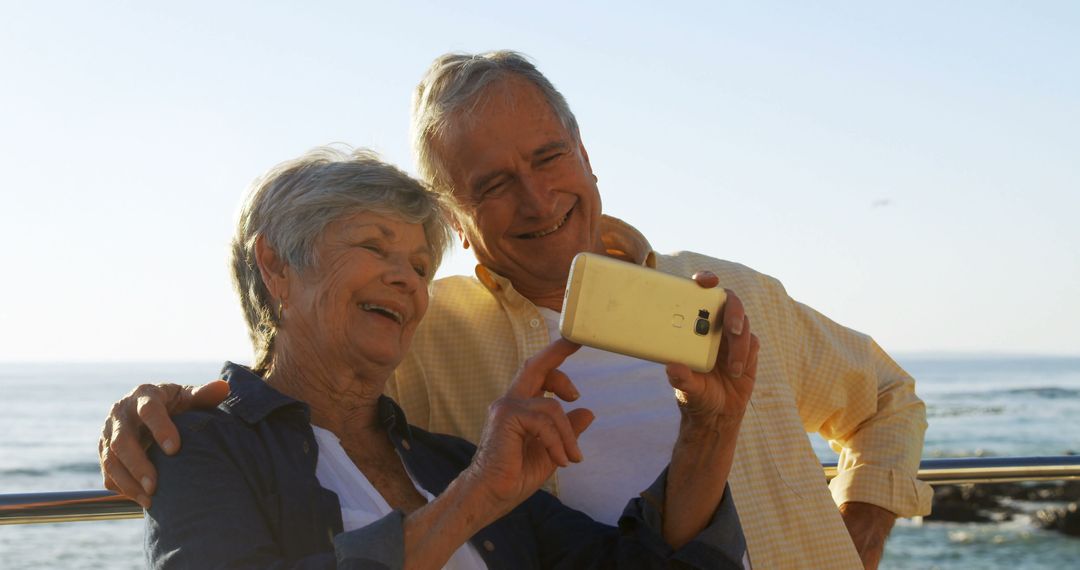 Happy Senior Couple Taking Selfie by the Beach - Free Images, Stock Photos and Pictures on Pikwizard.com