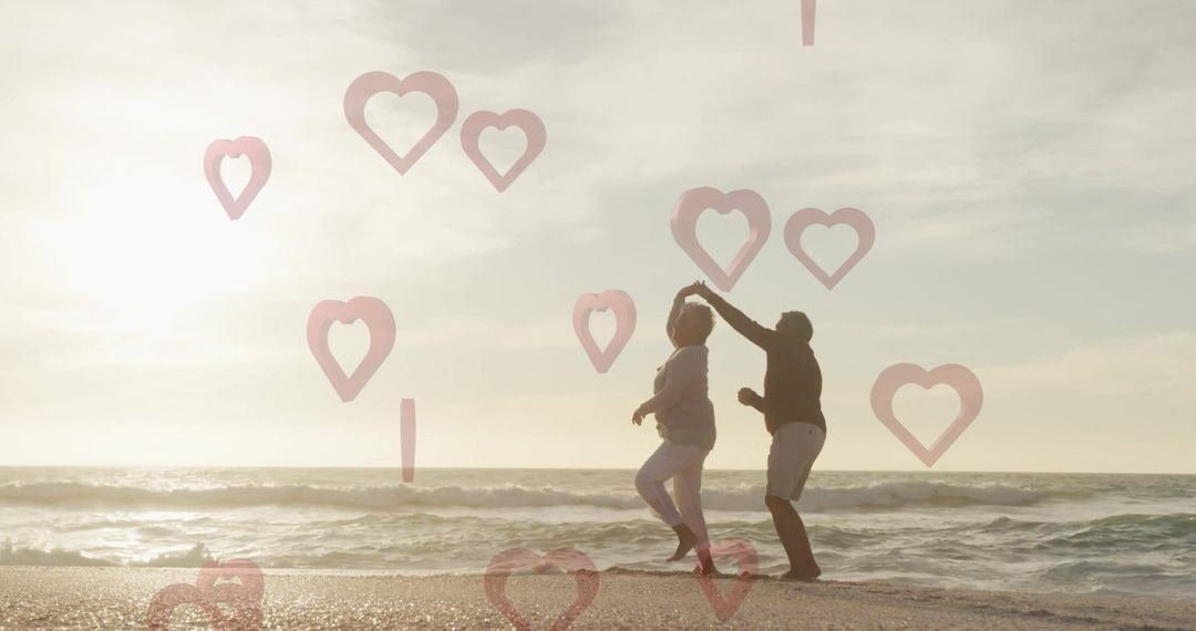Senior Couple Dancing on Beach at Sunset with Heart Overlays